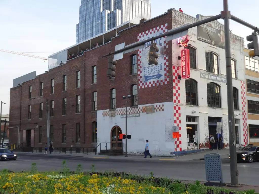 The brick Acme Feed and Seed building with its painted checkerboard trim at the river end of Broadway