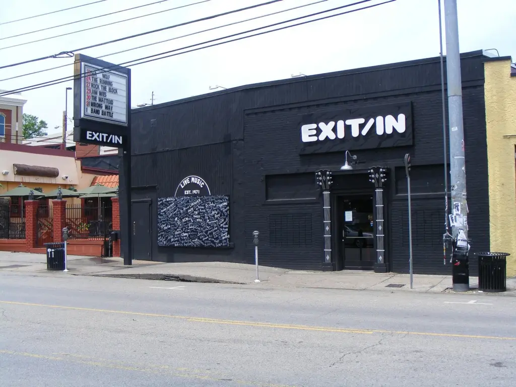 The black exterior of the Exit/In music club on Elliston Place with its marquee and a painted wall of band names