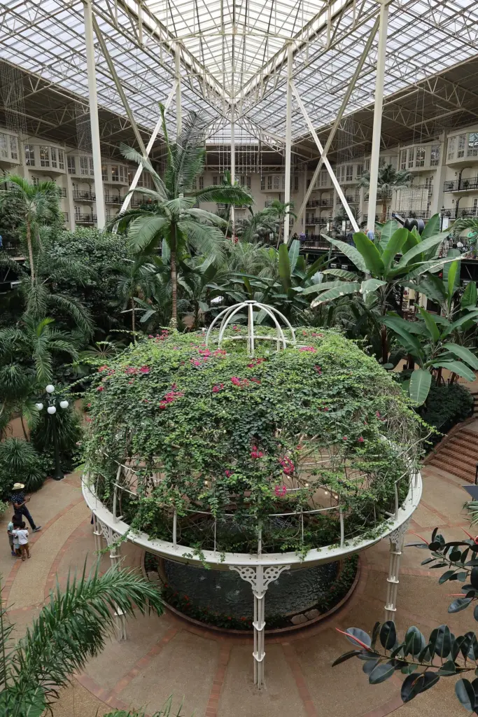 Tropical plants and a flower-covered dome inside Gaylord Opryland's glass-roofed Garden Conservatory