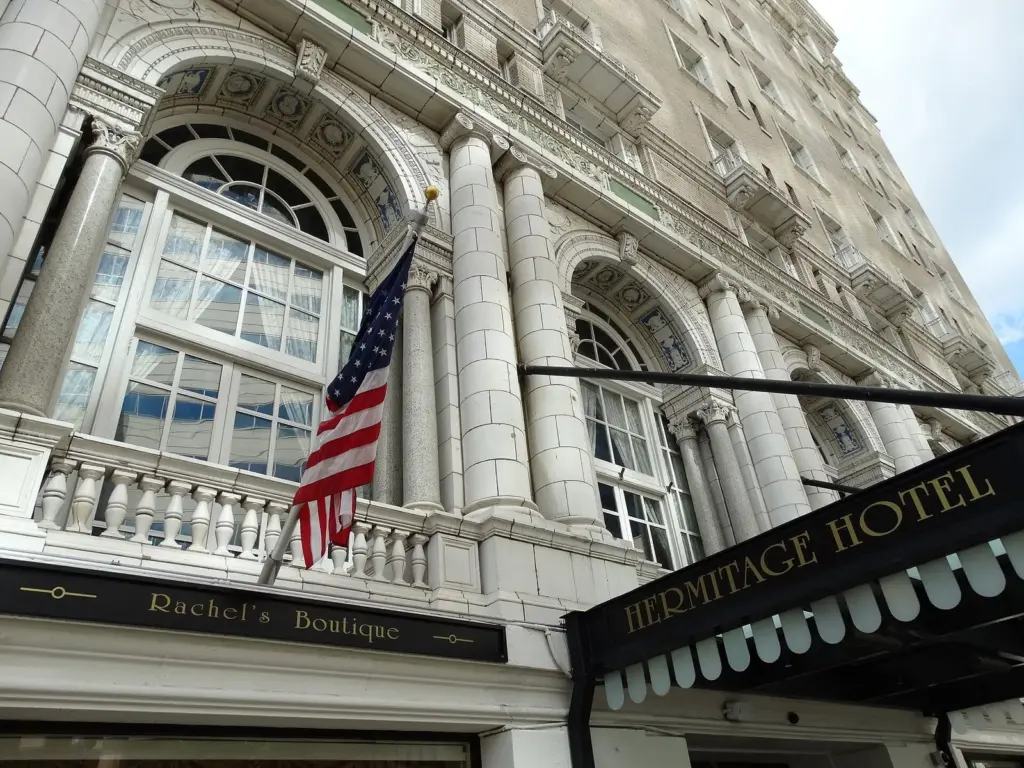 The arched entrance and flag-hung facade of the Hermitage Hotel on Sixth Avenue North