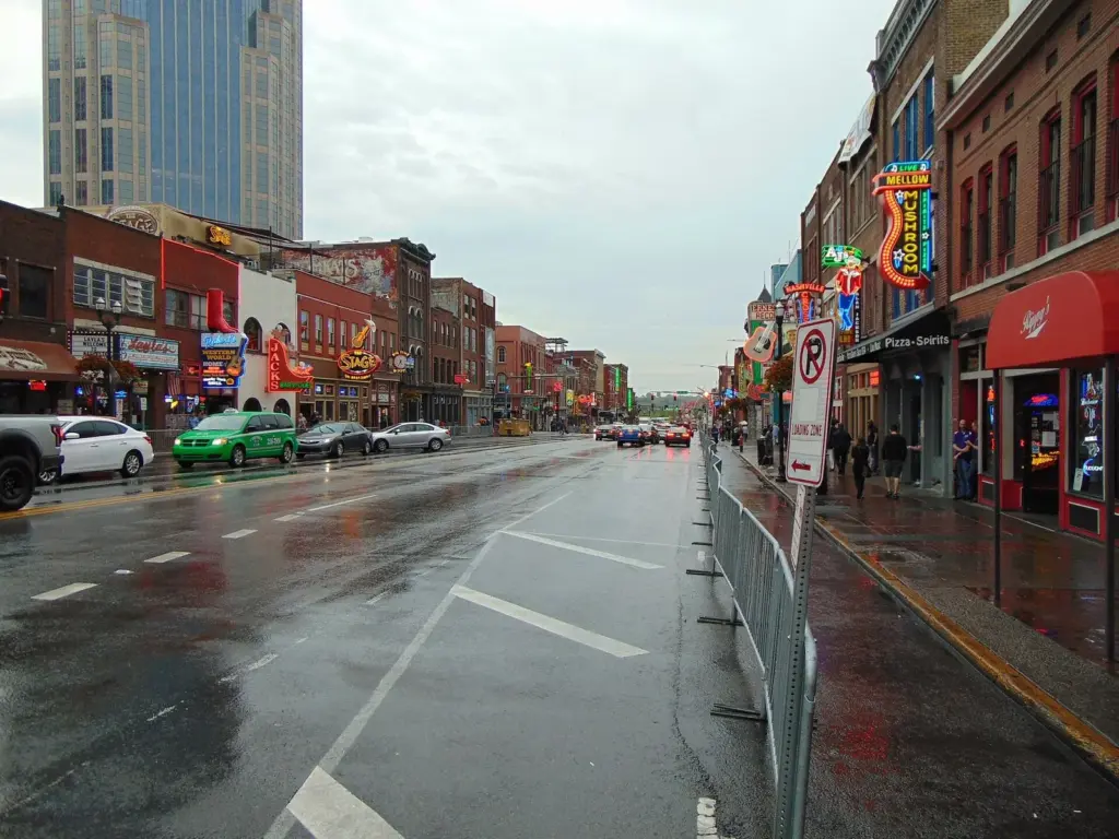 Lower Broadway on a wet afternoon, lined on both sides by the neon signs of Nashville honky tonks