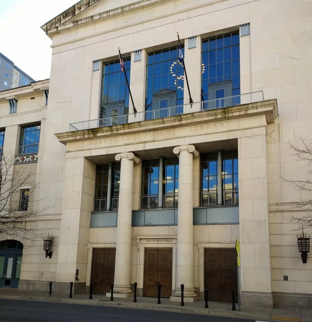 The pale stone facade of the Nashville Public Library's Main Library with tall columns and large windows