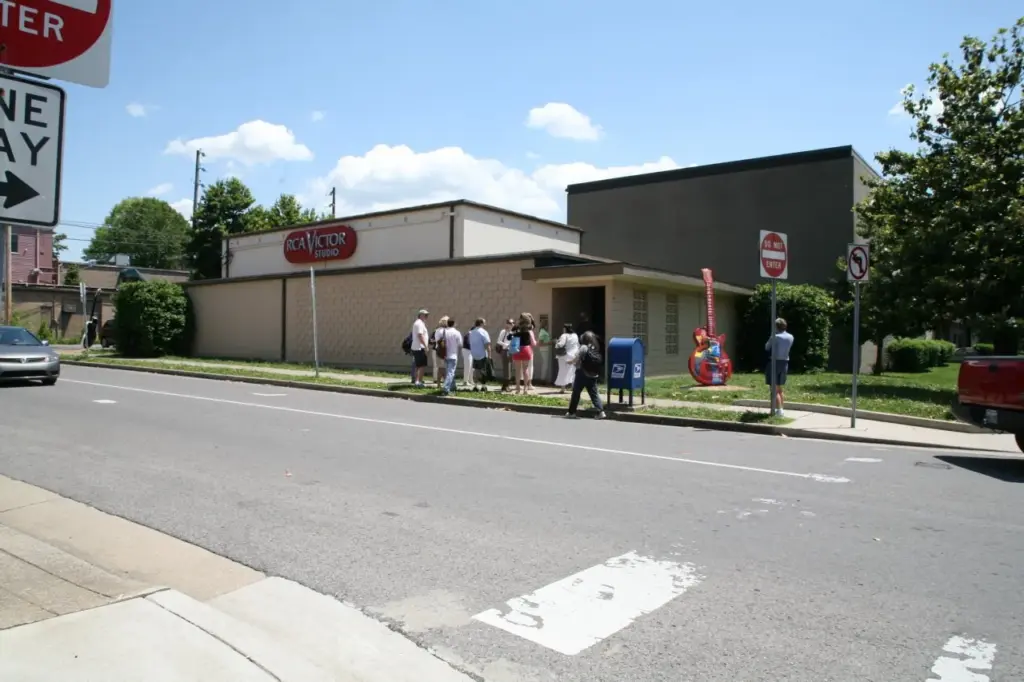 The low beige RCA Studio B building on Music Row with a tour group standing outside