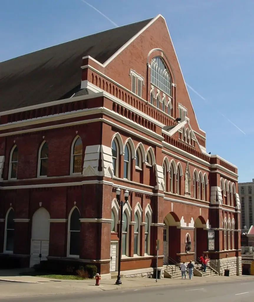 The red-brick Gothic Revival facade of the Ryman Auditorium under a clear blue sky