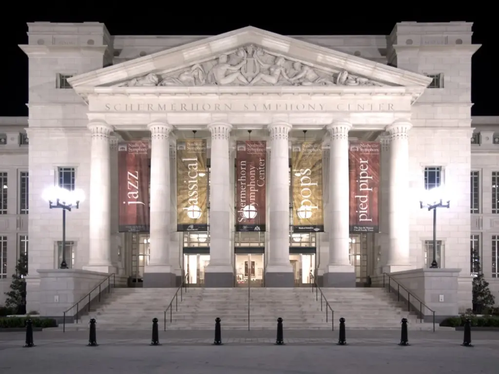 The columned, lit-up neoclassical facade of the Schermerhorn Symphony Center at night