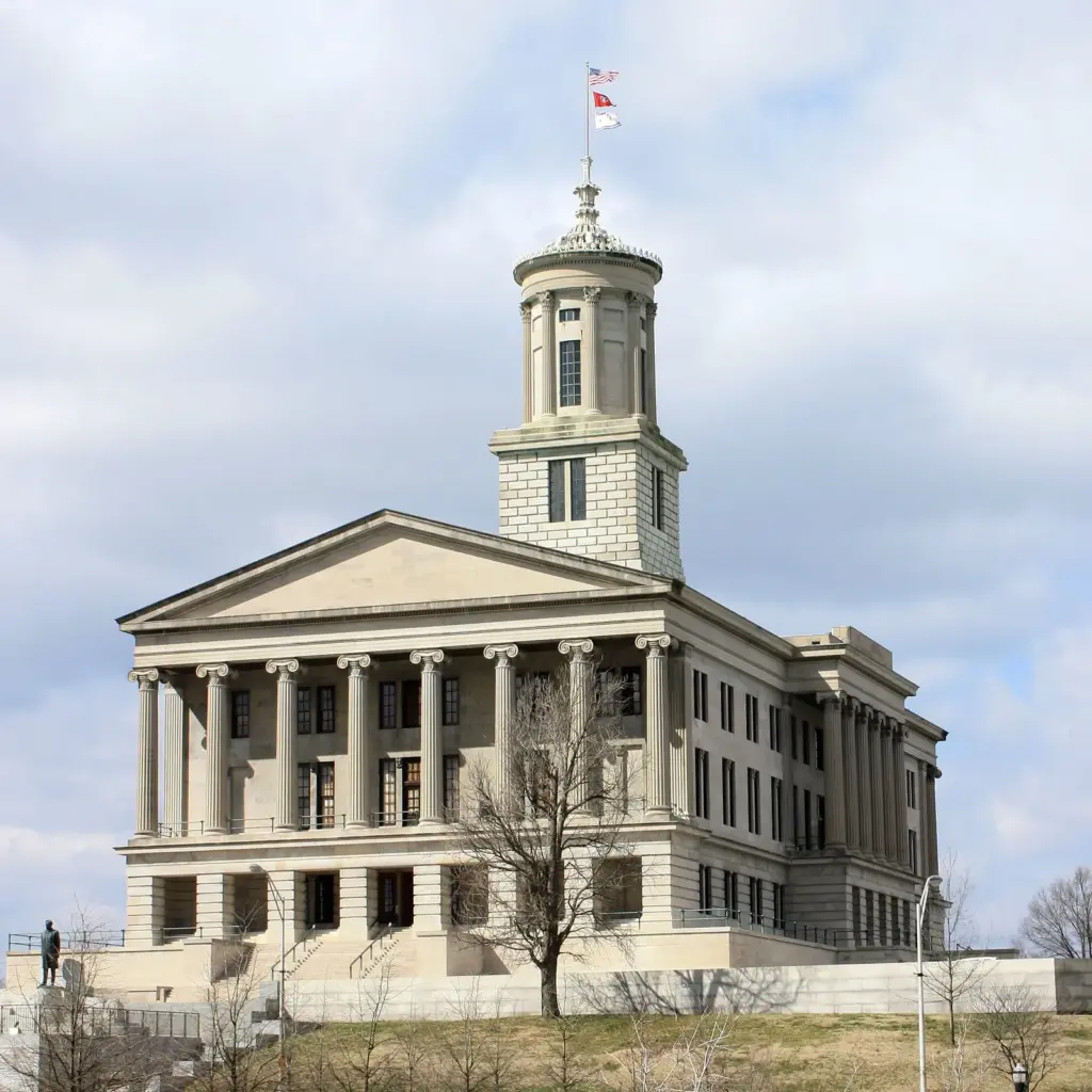 The limestone Tennessee State Capitol with its columned portico and central tower under a cloudy sky, one of the free Nashville attractions
