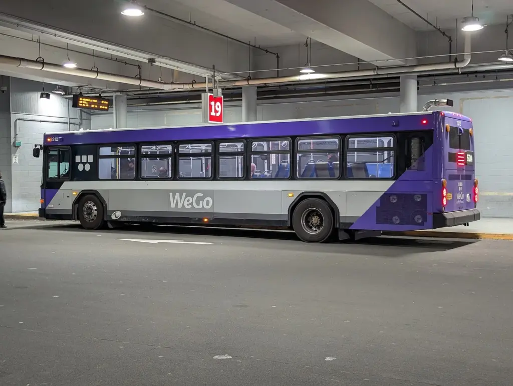 A purple and silver WeGo bus parked in a bay at the Elizabeth Duff Transit Center in downtown Nashville