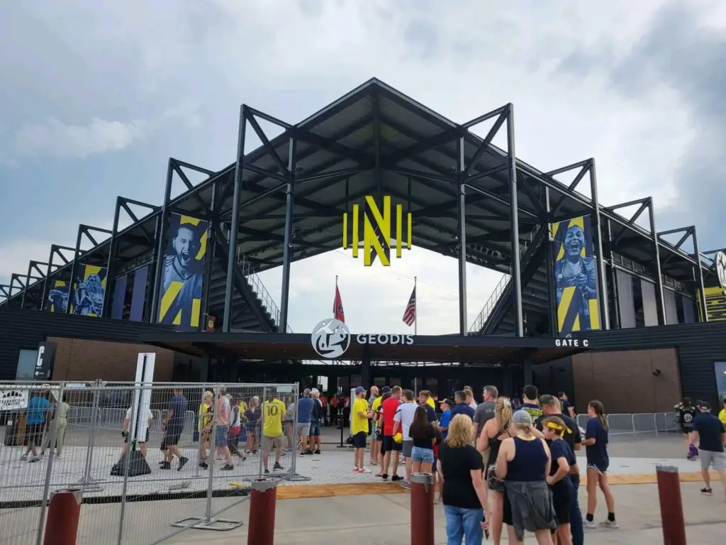Nashville SC fans lining up at Gate C of Geodis Park under its steel canopy