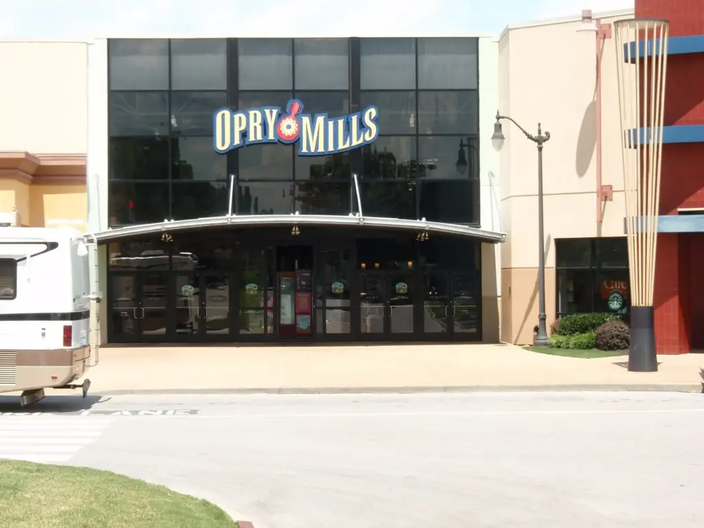 The entrance of Opry Mills mall with its sign above glass doors