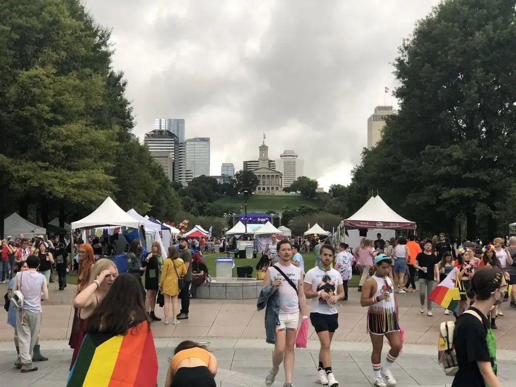 Crowds walking past festival tents at Bicentennial Capitol Mall during Nashville Pride, with the State Capitol behind